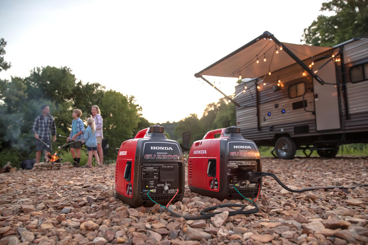 Portable generator running at a campsite with an RV in the background